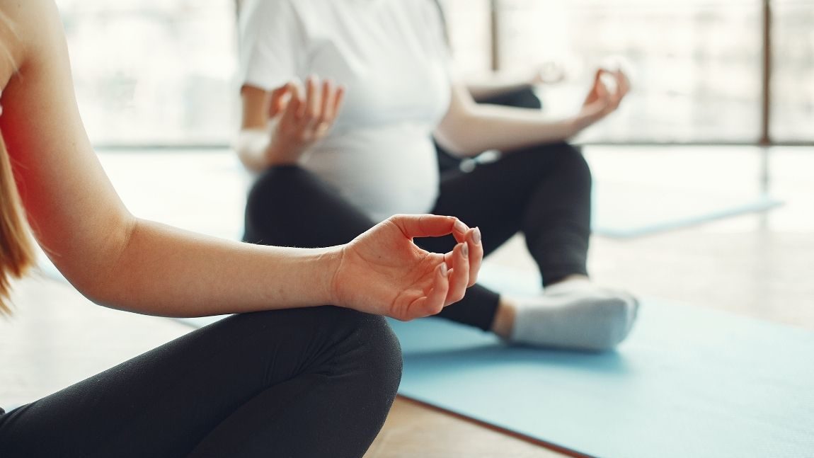 Pregnant women meditating